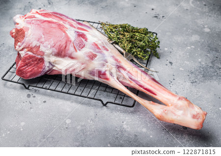 Raw whole lamb leg, fresh mutton meat. grey background. top view 122871815