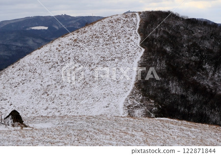Snowy landscape of the grassy mountain in Geopark 122871844