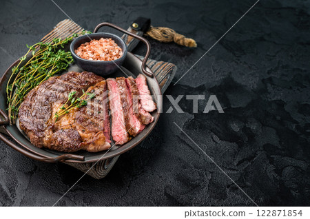 Grilled Rib eye prime steak, roasterd dry aged beef meat. black background. top view 122871854