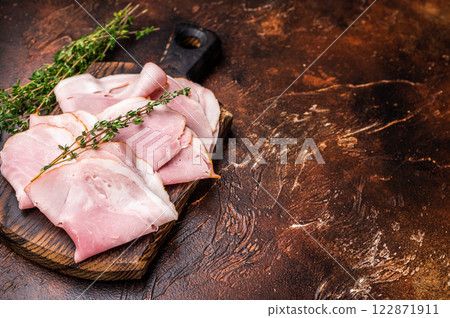 Ham Prosciutto Cotto, Sliced Pork Ham on wooden board. brown background. top view Ham Prosciutto Cotto, Sliced Pork Ham on wooden board. brown background. top view 122871911
