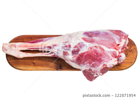 Whole raw lamb leg, uncooked mutton meat on butcher board isolated on white background. top view Whole raw lamb leg, uncooked mutton meat on butcher board isolated on white background. top view 122871954