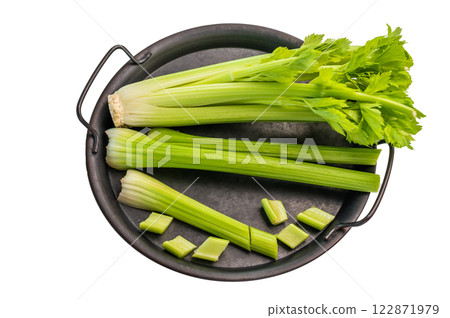 Sliced uncooked celery sticks in steel tray isolated on white background, top view Sliced uncooked celery sticks in steel tray isolated on white background, top view 122871979