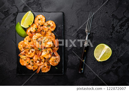 BBQ Roasted spicy Shrimps Prawns with garlic. Black background. Top view 122872007