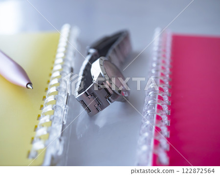A notebook and a clock on the table A notebook and a clock on the table 122872564