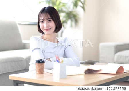 A young woman studying alone in the living room A young woman studying alone in the living room 122872566