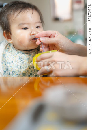 Baby eating baby food Baby eating baby food 122872608