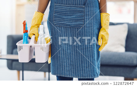 Cleaning service, product basket and cleaner for maid advertising or marketing in living room apartment, home or house. Woman housekeeping worker hands with spray bottle and liquid detergent in house 122872647