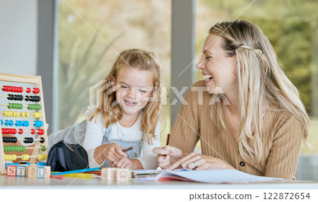 Math, school work and family learning education, comic conversation while studying in books and happy with student at table in home. Mother and girl doing homework for knowledge at desk in house 122872654