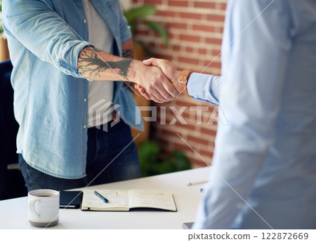business people shaking hands in office meeting after successful partnership deal for startup company business people shaking hands in office meeting after successful partnership deal for startup company 122872669