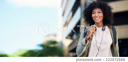 portrait african american woman smiling happy in city street wearing headphones 122872688