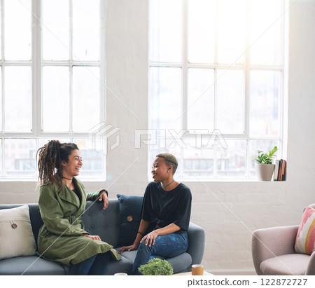 two woman friends talking having conversation sitting on sofa at home two woman friends talking having conversation sitting on sofa at home 122872727