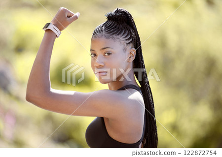 Fitness, flexing and black woman with muscle in nature ready for arms training, biceps and outdoor workout in summer. Portrait, lifestyle and strong African girl power with an active female athlete 122872754