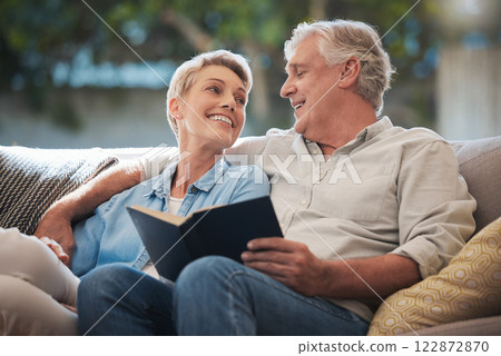 Senior, couple and pension people reading with a happy smile in a home living room sofa. Retirement of elderly man and woman smiling with calm happiness on a house couch with a book together 122872870