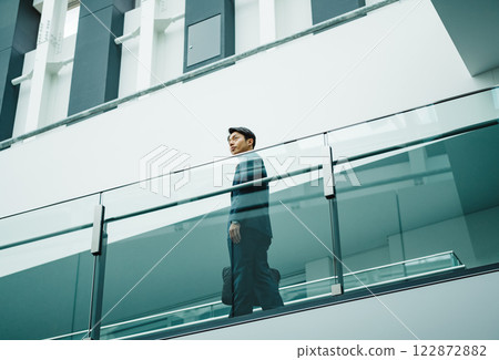 A young businessman in sales walking through a beautiful building 122872882