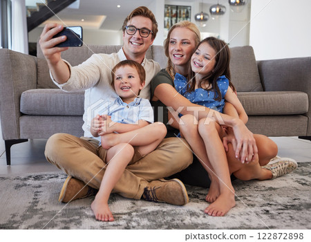 Selfie, phone and family with a man taking a picture with his children and their mother on the floor of their living room at home. Happy, love and kids with a brother and sister posing with parents 122872898