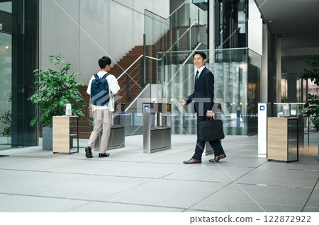Businessman passing through a security gate Businessman passing through a security gate 122872922