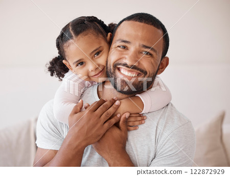 Children, family and love with a girl and her father hugging, embracing and bonding together in their home. Kids, smile and happy with a man and his daughter enjoying time with a loving expression 122872929