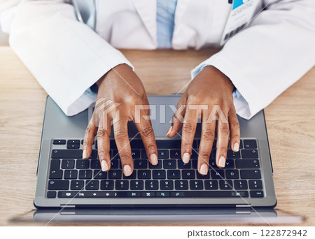 Hands, woman and doctor with laptop working at a desk in a hospital office. Medical expert with wireless technology to diagnose or research diseases in the field of health and medicine online or web 122872942