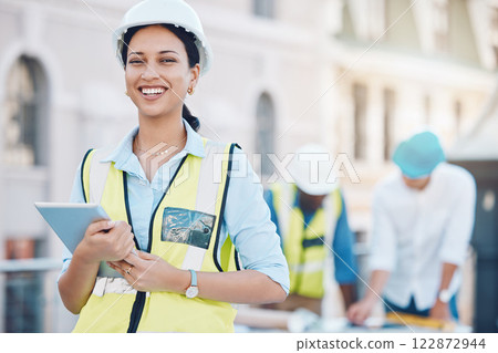 Construction, tablet and architecture with a woman builder or architect working on a building site in the city. Engineer, design and technology with a female designer and her team in the background 122872944