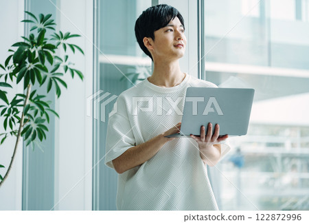 Portrait of a young engineer working in the office 122872996