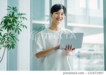 Portrait of a young engineer working in the office 122872997