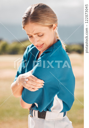 Baseball, sport and arm pain or injury on the field after an accident during the game or training. Woman sports athlete with medical emergency of muscle or joint with a sprain after match or exercise Baseball, sport and arm pain or injury on the field after an accident during the game or training. Woman sports athlete with medical emergency of muscle or joint with a sprain after match or exercise 122873045