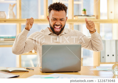 Black man, winner and celebrating stock sale, profit and success online with laptop. Business trader gets high return, reward for investment and crypto currency. Excited, happy and cheering economist 122873048