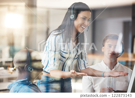 Call center, team manager training employees with computer in presentation meeting at a workplace office. Teamwork and leadership woman coaching telemarketing customer service agent with online talk 122873143