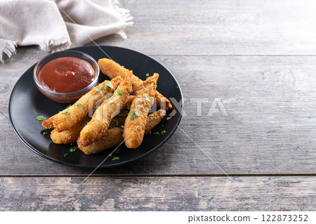 Breaded Torpedo shrimps on wooden table 122873252
