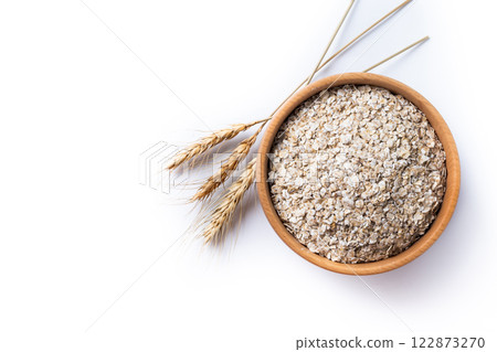 Rolled oats, healthy breakfast cereal oat flakes in bowl isolated on white background 122873270