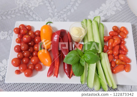 vegetable slicing plate with vegetables vegetables tomatoes cucumbers pepper basil 122873342