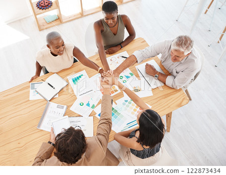 Teamwork, meeting and hands together after a branding and logo group discussion at a business office table. Motivation, diversity and collaboration for our vision, mission plan and goals top view 122873434