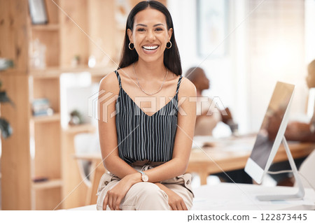 Smile, happy and business woman, desk portrait at work with blurred background. Leadership, motivation and smiling manager, leader or employee sitting with success, vision and confidence in office Smile, happy and business woman, desk portrait at work with blurred background. Leadership, motivation and smiling manager, leader or employee sitting with success, vision and confidence in office 122873445