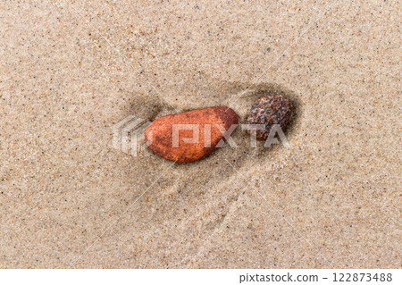 Pebble stones in fine sea sand Pebble stones in fine sea sand 122873488
