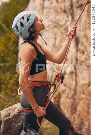 Rope, rock climber and woman mountain climbing in nature for exercise, endurance and body training outdoors. Fitness, challenge and fearless girl ready to climb a rocky cliff on a dangerous adventure Rope, rock climber and woman mountain climbing in nature for exercise, endurance and body training outdoors. Fitness, challenge and fearless girl ready to climb a rocky cliff on a dangerous adventure 122873543