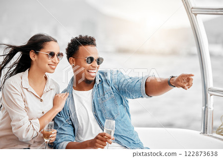 Couple love to travel on a luxury yacht at sea together on a romantic date in nature on a holiday vacation. Smile, happy and young boyfriend and woman enjoy champagne in the ocean on a boat cruise 122873638