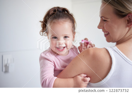 Mother teaching happy girl dental hygiene, baby toothbrush and mom holding kid. Clean teeth, home healthcare and portrait of child growth. Laugh in children bathroom, healthy mouth and natural smile Mother teaching happy girl dental hygiene, baby toothbrush and mom holding kid. Clean teeth, home healthcare and portrait of child growth. Laugh in children bathroom, healthy mouth and natural smile 122873732