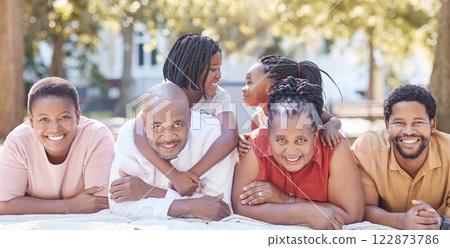 Nature, garden and portrait of a happy black family relaxing together while on summer vacation. Smile, park and positive african people on a picnic outside while on a holiday in the countryside. 122873786