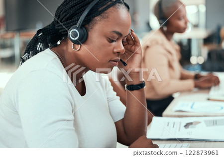 Black woman, call center and customer service online support workers at the office with headset. African female consultant, crm and telemarketing agent at work or company group helpdesk team. 122873961