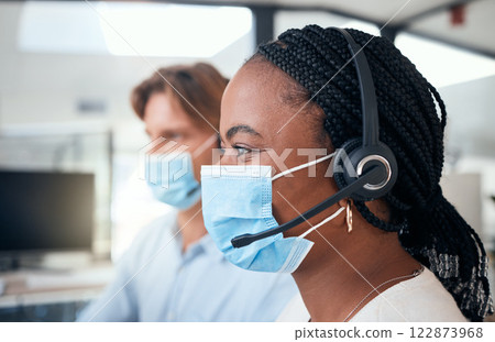 Black call center woman with mask, customer service and telemarketing agent stoping the spread of covid. Crm, contact us and helpdesk worker with headset offering help, support and friendly service. Black call center woman with mask, customer service and telemarketing agent stoping the spread of covid. Crm, contact us and helpdesk worker with headset offering help, support and friendly service. 122873968