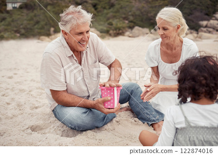 Happy, sand and grandparents playing with their grandchildren at the beach during summer. Positive elderly man and woman building sandcastle with their grandkids by the ocean while on family vacation 122874016
