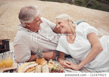 Love, couple and picnic with a senior man and woman on an outdoor date with food and juice in summer. Happy, smile and romance with an elderly male and female enjoying free time together and bonding Love, couple and picnic with a senior man and woman on an outdoor date with food and juice in summer. Happy, smile and romance with an elderly male and female enjoying free time together and bonding 122874023