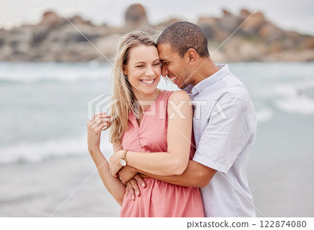 Travel, beach and couple hug, happy and laughing while bonding outdoors, enjoying the view of the ocean. Love, relationship and water fun with relax man and woman on seaside trip in San francisco Travel, beach and couple hug, happy and laughing while bonding outdoors, enjoying the view of the ocean. Love, relationship and water fun with relax man and woman on seaside trip in San francisco 122874080