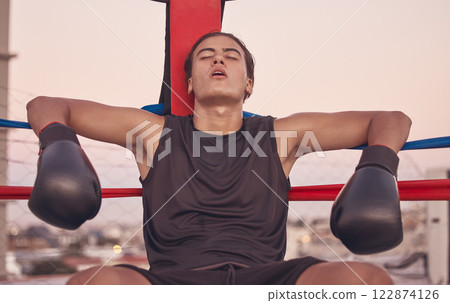 Sports, boxing ring and tired frustrated boxer with low energy, injury or fatigue from exhibition competition. Loser or failure in fight challenge, workout or training burnout from fitness exercise 122874126