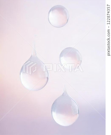 Clear water droplets floating on a white background. Soft and transparent cosmetic background material 122874357