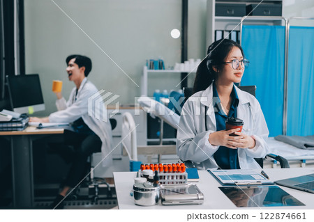 Medicine doctor hand working with modern digital tablet computer and holding coffee cup on white desk Medicine doctor hand working with modern digital tablet computer and holding coffee cup on white desk 122874661