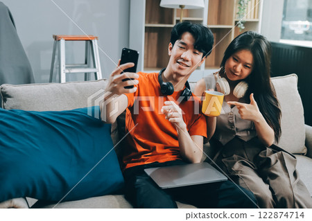 Smiling couple unpacking boxes in new house 122874714