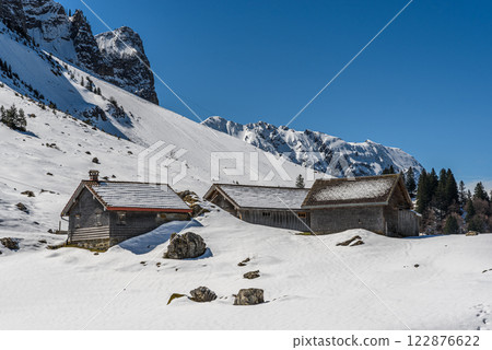 Wooden huts in the snow in the Swiss Alps, Switzerland 122876622