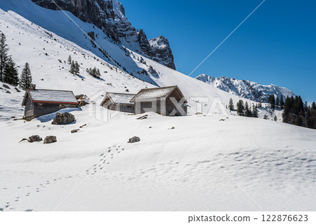 Wooden huts in the snow in the Swiss Alps, Switzerland 122876623