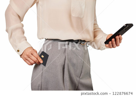 woman in white shirt holding mobile phone and black premium credit bank card on white background. Online shopping. 122876674